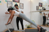 Woman practicing Pilates on a mat during a core-strengthening workout session.