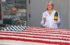 Martha Stewart poses beside a giant American flag cake created for her Founding Father-themed celebration honoring America's 250th anniversary.