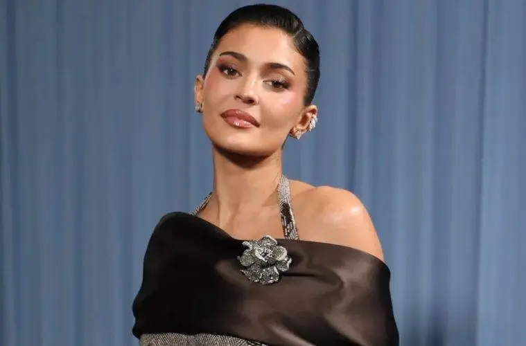 Kylie Jenner poses at a public event wearing a stylish designer outfit, highlighting her signature beauty and fashion aesthetic.