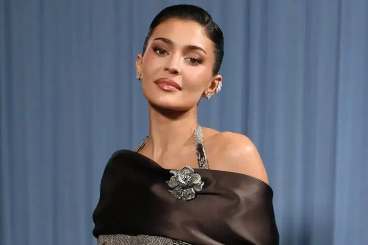 Kylie Jenner poses at a public event wearing a stylish designer outfit, highlighting her signature beauty and fashion aesthetic.