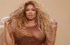 Lizzo poses on the 2026 BET Awards red carpet wearing a shimmering sheer brown gown with sparkling embellishments.