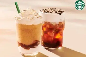 Starbucks' returning S'mores Frappuccino sits beside the new S'mores Cold Brew, both topped with marshmallow-inspired flavors and graham cracker crumbs.