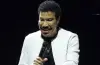 Lionel Richie performing on stage during a concert before reportedly becoming ill and ending the show early.