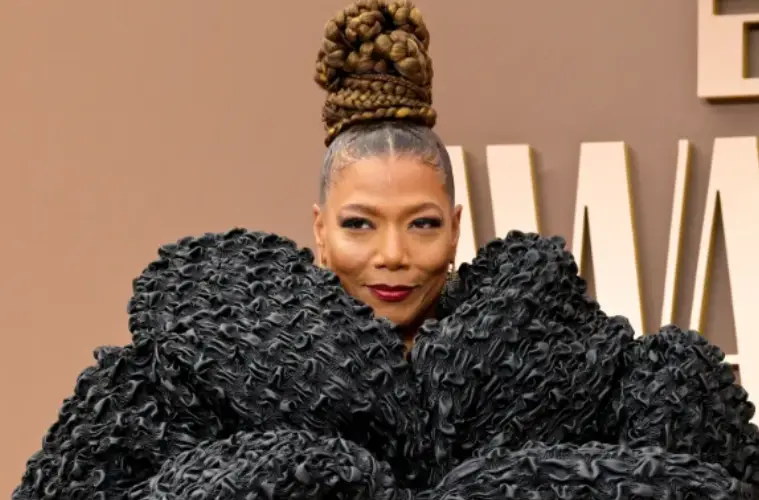 Queen Latifah posing on the red carpet at the 2026 BET Awards in an elegant and stylish outfit.