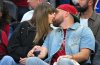 Taylor Swift and Travis Kelce attending a public event as reports about a possible wedding NDA generate widespread discussion.