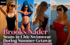 Brooks Nader poses in a black one-piece swimsuit during her summer vacation by the waterfront.