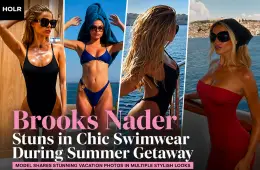 Brooks Nader poses in a black one-piece swimsuit during her summer vacation by the waterfront.