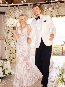 MrBeast and Thea Booysen smiling together in their wedding attire after announcing their marriage on Instagram.