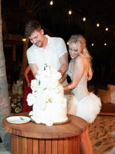 MrBeast and Thea Booysen smiling together in their wedding attire after announcing their marriage on Instagram.