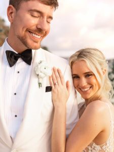 MrBeast and Thea Booysen smiling together in their wedding attire after announcing their marriage on Instagram.