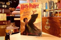 Fans dressed as Hogwarts students gather outside a bookstore during the midnight release of Harry Potter and the Deathly Hallows, celebrating the final book in J.K. Rowling's iconic series.