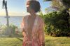 Halle Berry walking along a tropical beach in a pink floral cover-up during her latest Instagram post.