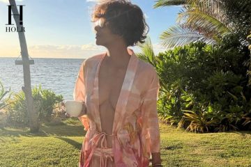 Halle Berry walking along a tropical beach in a pink floral cover-up during her latest Instagram post.