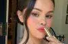 Selena Gomez applying Rare Beauty's new Soft Pinch Lip Oil Stick before its official launch.