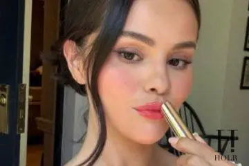 Selena Gomez applying Rare Beauty's new Soft Pinch Lip Oil Stick before its official launch.