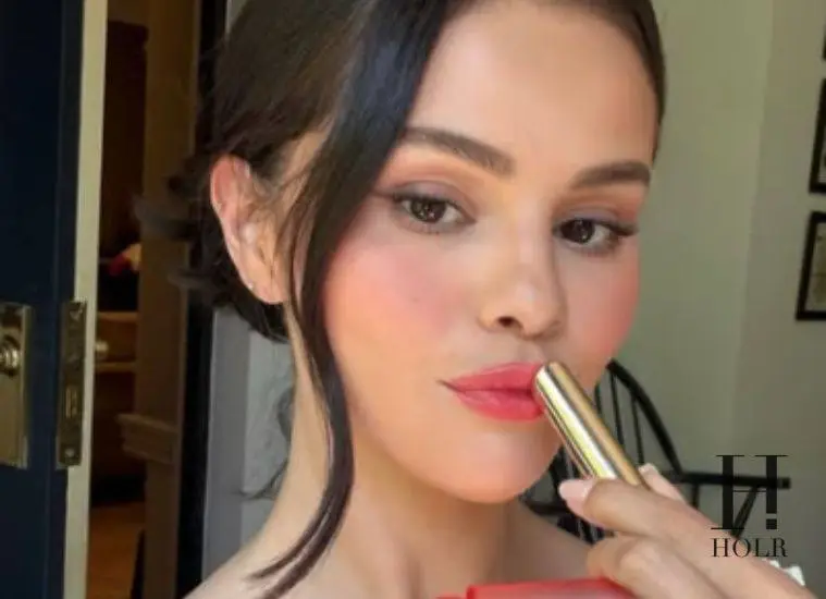 Selena Gomez applying Rare Beauty's new Soft Pinch Lip Oil Stick before its official launch.