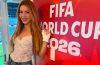 Shakira poses beside a FIFA World Cup 2026 display during a football event.
