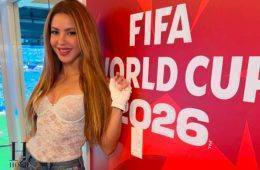 Shakira poses beside a FIFA World Cup 2026 display during a football event.