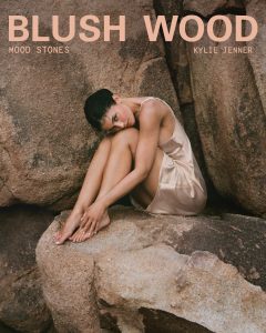 Kylie Jenner poses with the new Mood Stones fragrance trio from Kylie Cosmetics.