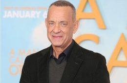 Tom Hanks smiles while attending a Hollywood premiere celebrating his decades-long acting career.