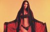 Megan Fox wearing gothic-inspired black lingerie and a flowing veil in a dramatic editorial photoshoot that recalls Jennifer's Body.