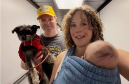 Erin Krakow and Ben Rosenbaum smiling during a family flight while travelling with their baby girl for the first time.