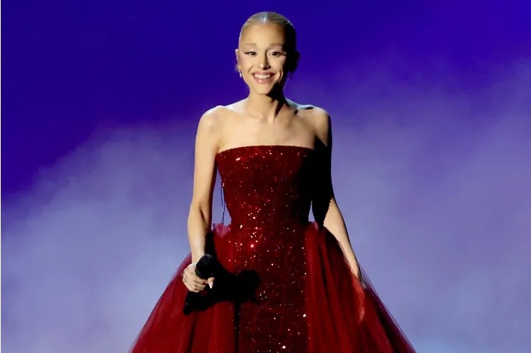 Ariana Grande performing on stage during her concert after overcoming a brief microphone malfunction.