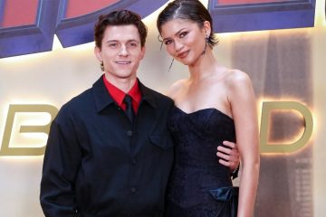Zendaya and Tom Holland attending the Spider-Man: Brand New Day premiere, smiling together on the red carpet.