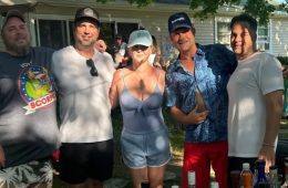 Amy Schumer smiles in a blue swimsuit while celebrating the Fourth of July with longtime friends.