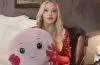 Madonna smiles while holding Octavia, the stuffed octopus she says reminds her of the nurse who cared for her during her recovery from a life-threatening illness.