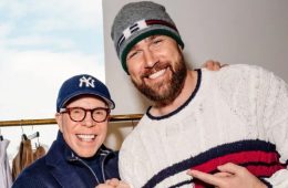 Travis Kelce arriving at a fashion event in a tailored designer outfit.