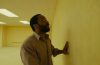 A haunting scene from A24's Backrooms featuring the film's signature endless yellow hallways now available to watch at home.
