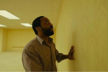 A haunting scene from A24's Backrooms featuring the film's signature endless yellow hallways now available to watch at home.