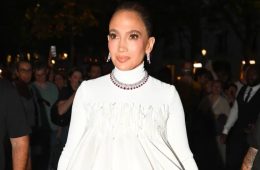 Jennifer Lopez wearing a couture gown and sparkling diamond jewelry while celebrating her 57th birthday in Paris.