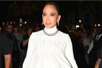 Jennifer Lopez wearing a couture gown and sparkling diamond jewelry while celebrating her 57th birthday in Paris.