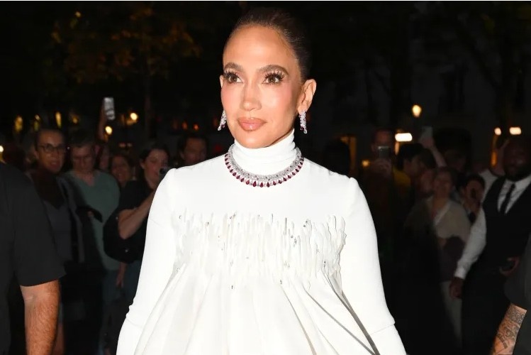 Jennifer Lopez wearing a couture gown and sparkling diamond jewelry while celebrating her 57th birthday in Paris.