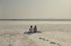 Two women share a quiet moment in The Lion at My Back, reflecting the film's themes of friendship and resilience against the backdrop of Cyprus.
