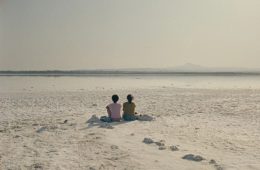 Two women share a quiet moment in The Lion at My Back, reflecting the film's themes of friendship and resilience against the backdrop of Cyprus.