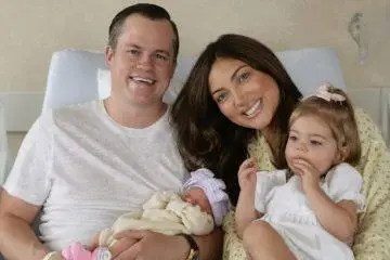 Campbell "Pookie" Puckett and Jett Puckett pose with their two daughters in their first family photos as a family of four.