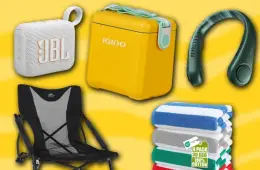 A collection of beach essentials including chairs, umbrellas, coolers, towels, sunglasses, and waterproof bags arranged on a sunny beach.