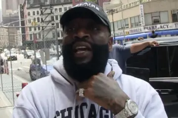 Rick Ross speaking at an event after expressing interest in purchasing an ownership stake in the Miami Dolphins NFL franchise.