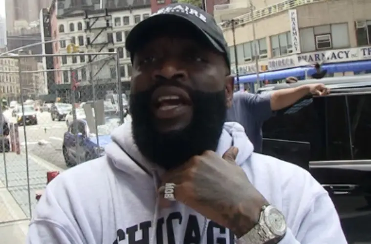 Rick Ross speaking at an event after expressing interest in purchasing an ownership stake in the Miami Dolphins NFL franchise.