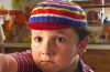 Paulie Litt as Spritle in the 2008 Speed Racer movie, smiling alongside Chim Chim during one of the film's memorable family moments.