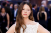 Mia Goth poses on the red carpet at The Odyssey premiere, wearing an elegant designer outfit during the star-studded event.
