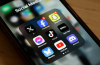 A teenager using a smartphone while the U.K. government considers new social media curfew proposals and online safety measures for young users.