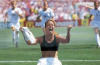 Brandi Chastain celebrates after scoring the winning penalty kick for the United States in the 1999 FIFA Women's World Cup Final, one of the most iconic moments in sports history.