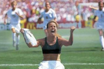 Brandi Chastain celebrates after scoring the winning penalty kick for the United States in the 1999 FIFA Women's World Cup Final, one of the most iconic moments in sports history.