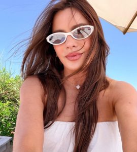 Sofía Vergara wearing a strapless white gown with elegant semi-sheer detailing before attending Michael Rubin's annual White Party.