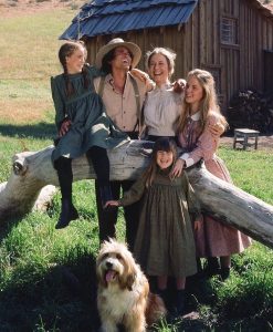 The Ingalls family standing together on the American prairie in Netflix's Little House on the Prairie adaptation, highlighting the series' sweeping landscapes and family-centered storytelling.