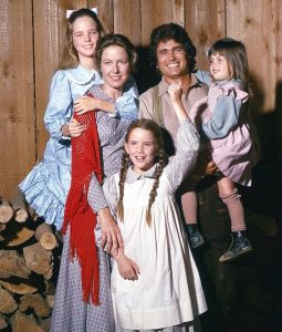The Ingalls family standing together on the American prairie in Netflix's Little House on the Prairie adaptation, highlighting the series' sweeping landscapes and family-centered storytelling.